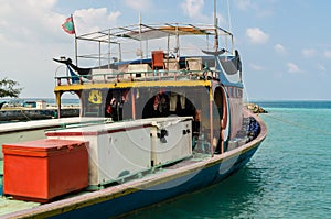 MALDIVES Ã¢â¬â November 17, 2017: Bright fishing boat near the pier, tropical Gulhi island in Indian Ocean, Maldives photo